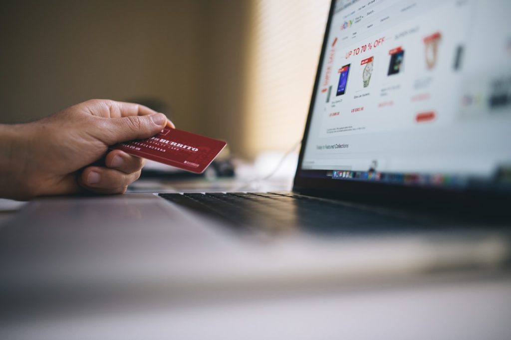 A person prepares to make a credit card purchase online.