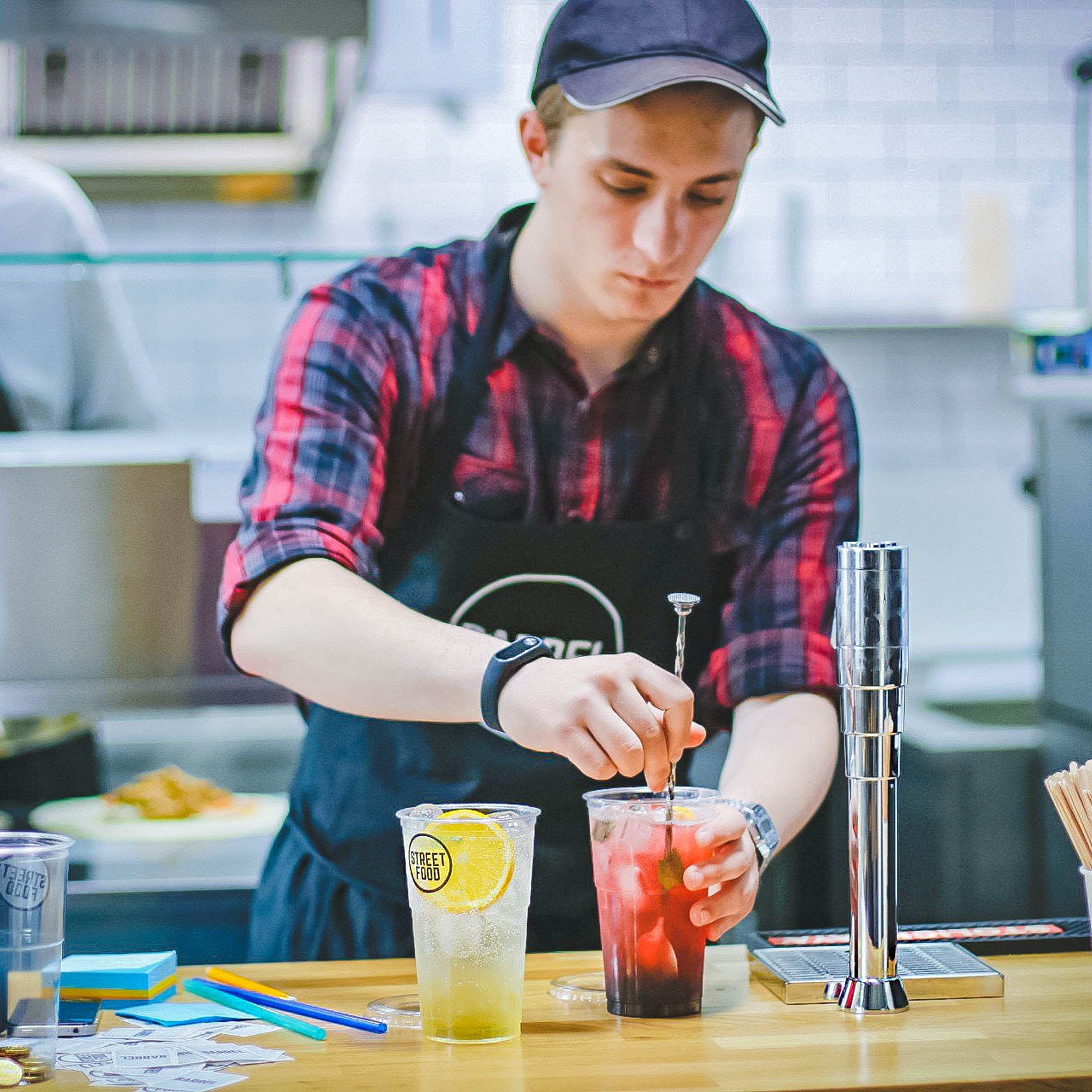 A restaurant server preparing a drink