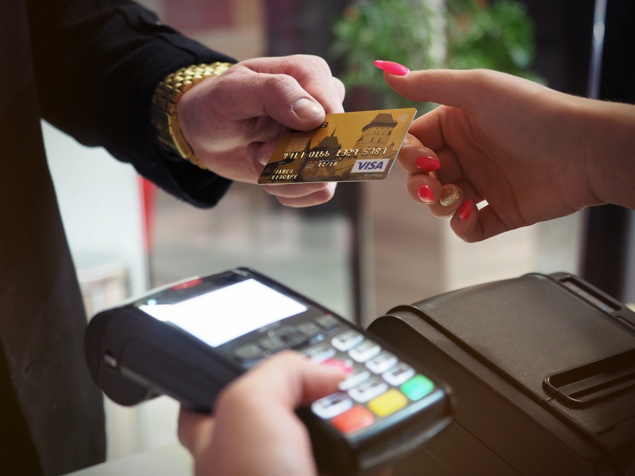 A customer pays using a credit card reader