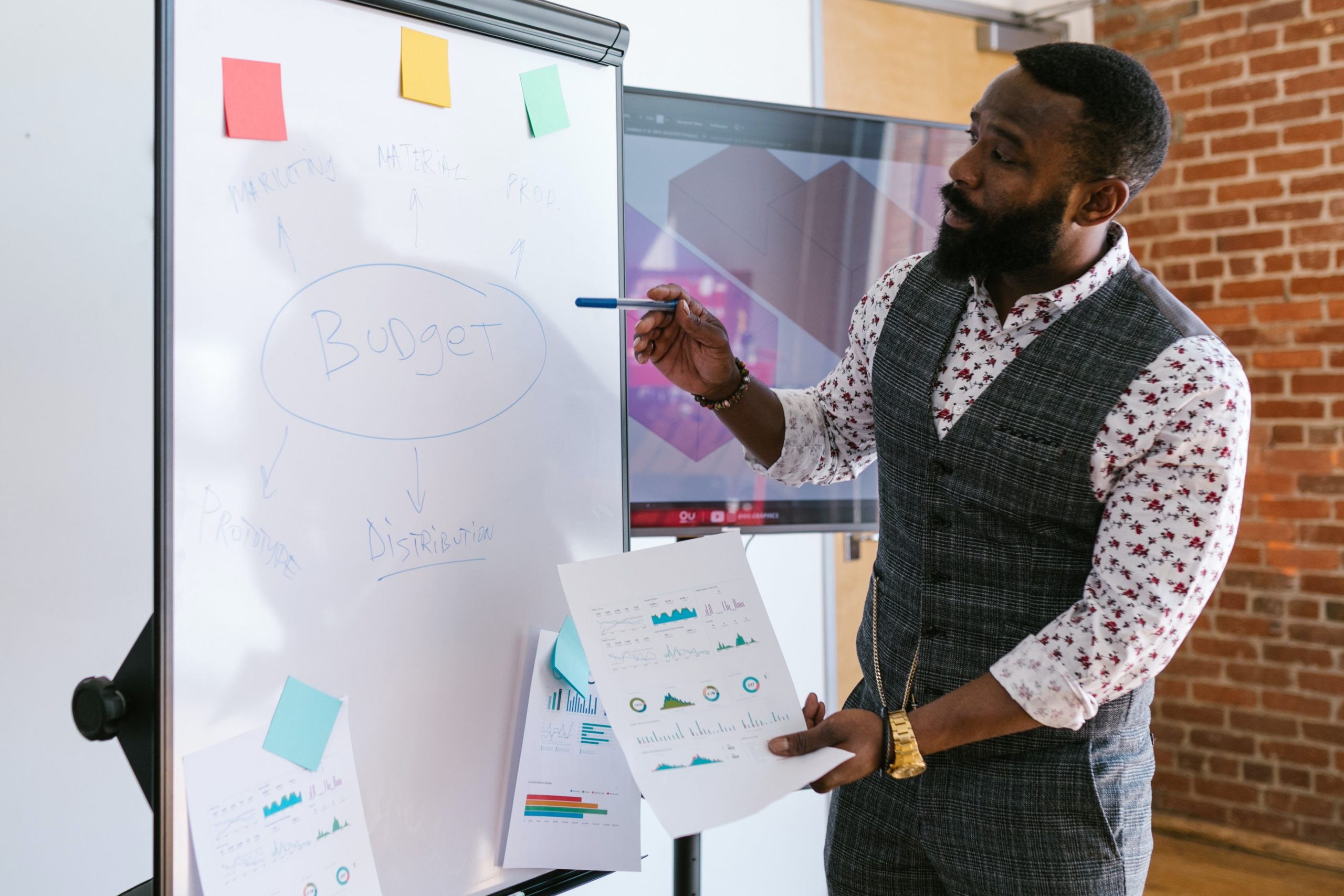 Man discussing business finances using a whiteboard