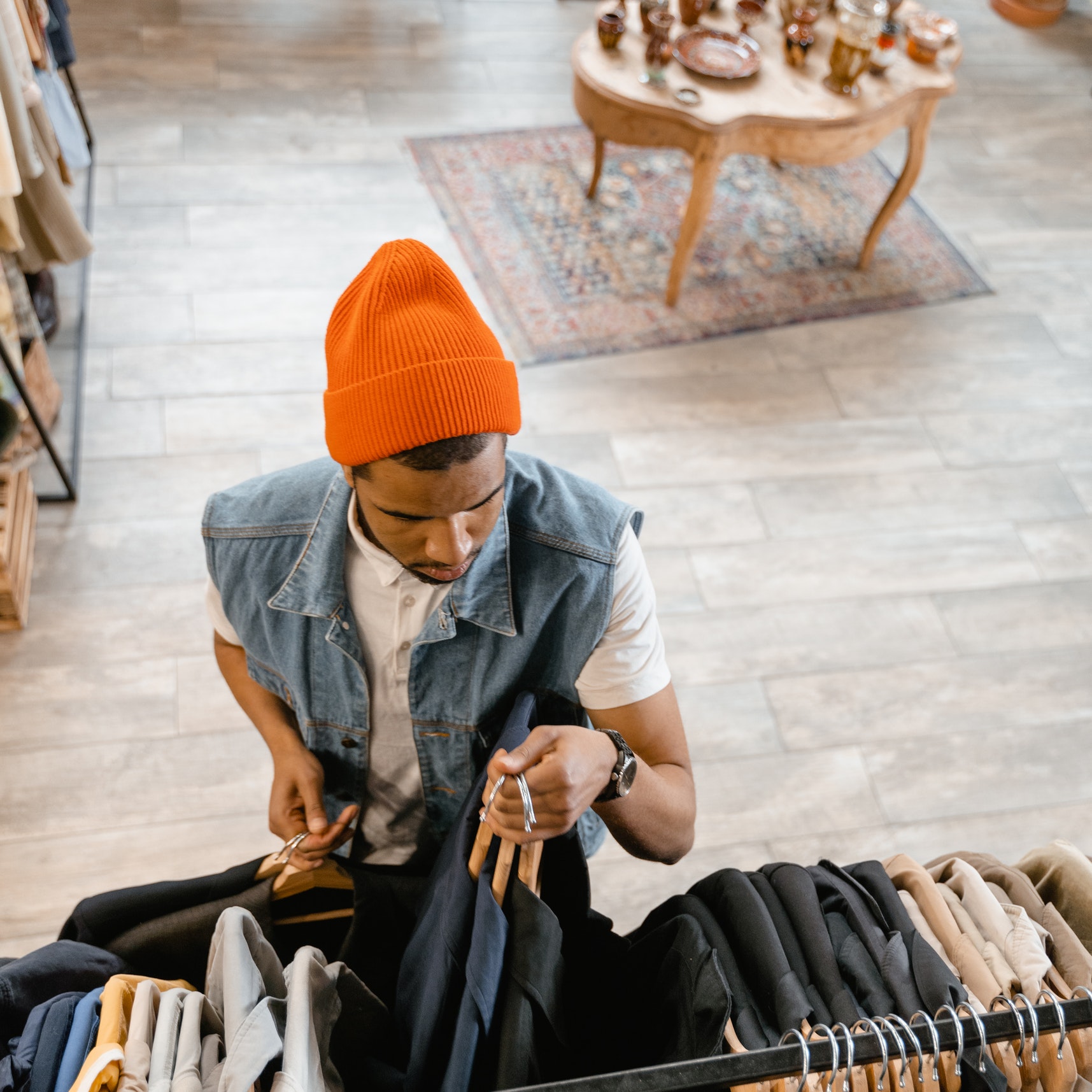 A man browses suit jackets in a clothing store