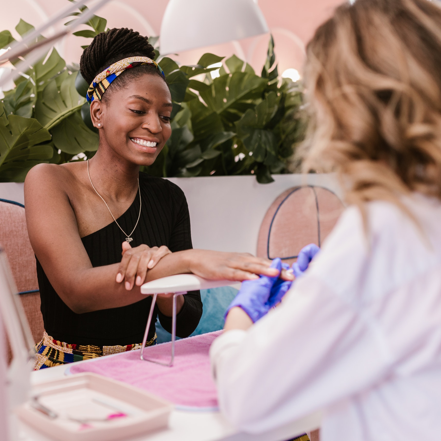 A woman receives a manicure at a nail salon