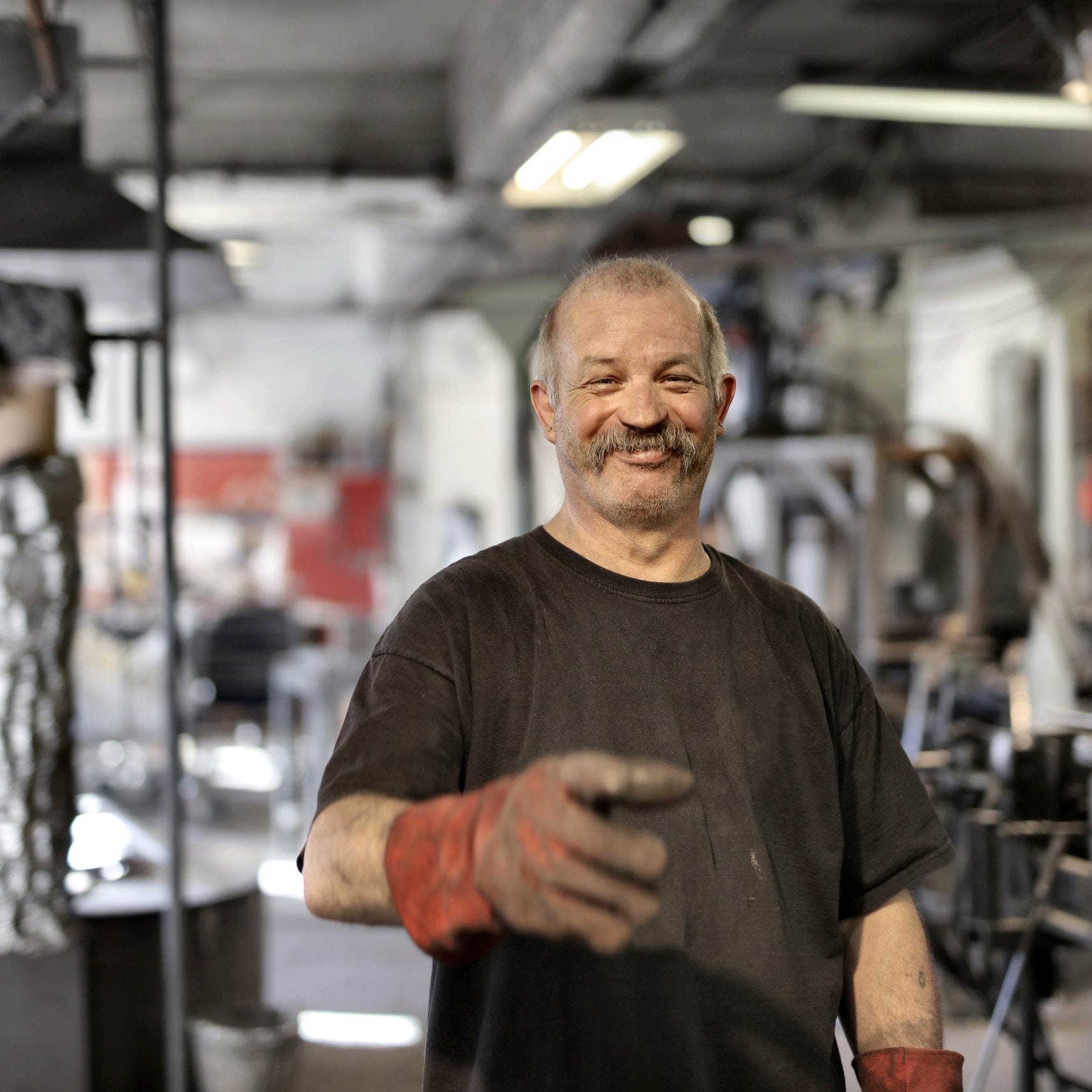 A smiling mechanic in his workshop