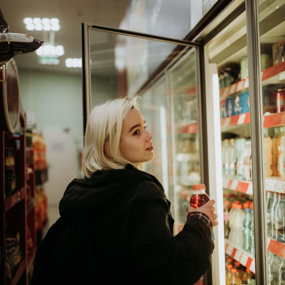 Woman picking out a drink at the gas station