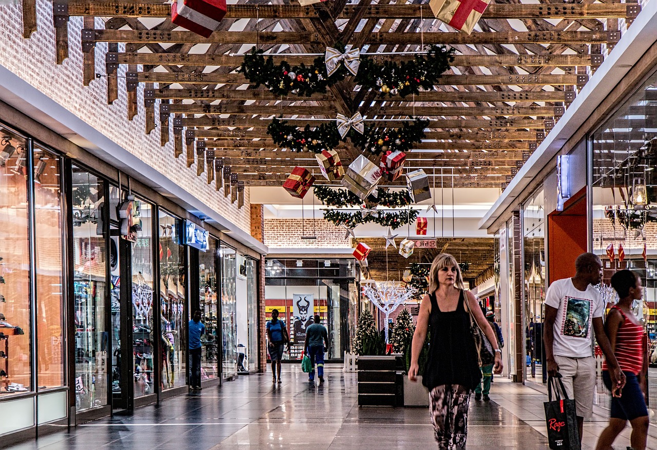 Shoppers at an indoor mall decorated for the holidays